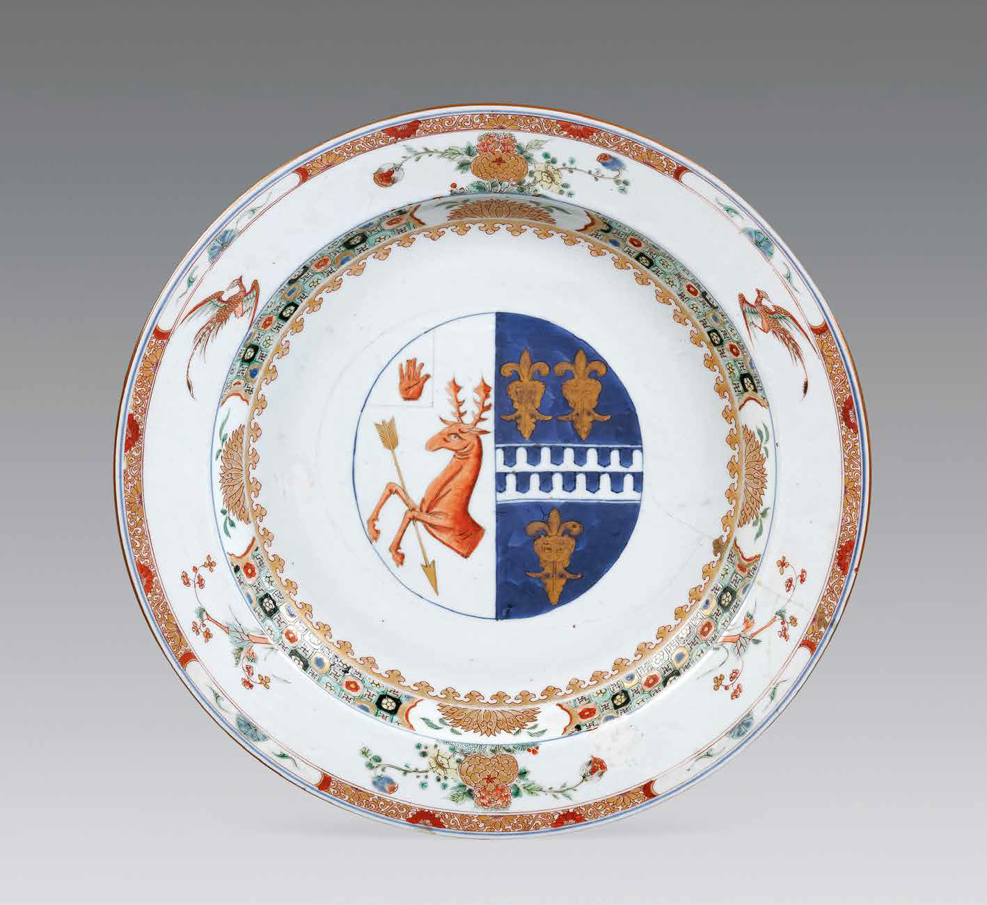 “外銷瓷”是指我國生產(chǎn)的，專門銷往國外的瓷器，清代“一口通商”時期，中國瓷器遠(yuǎn)銷歐美，對歐美人民生活影響深遠(yuǎn)。這一時期輸出的瓷器種類眾多，有粉彩、廣彩、青花、五彩等，器物造型及紋飾圖案既保留了中國制瓷藝術(shù)的傳統(tǒng)特征，又汲取了歐美的藝術(shù)精華，從而燒制出了大量精美的瓷器。圖為清康熙Decker家族和Watkins家族聯(lián)姻紋章大盤。外銷瓷中常見兩個家族組合紋章的紋章瓷，這樣的瓷器通常是為家族成員聯(lián)姻而定